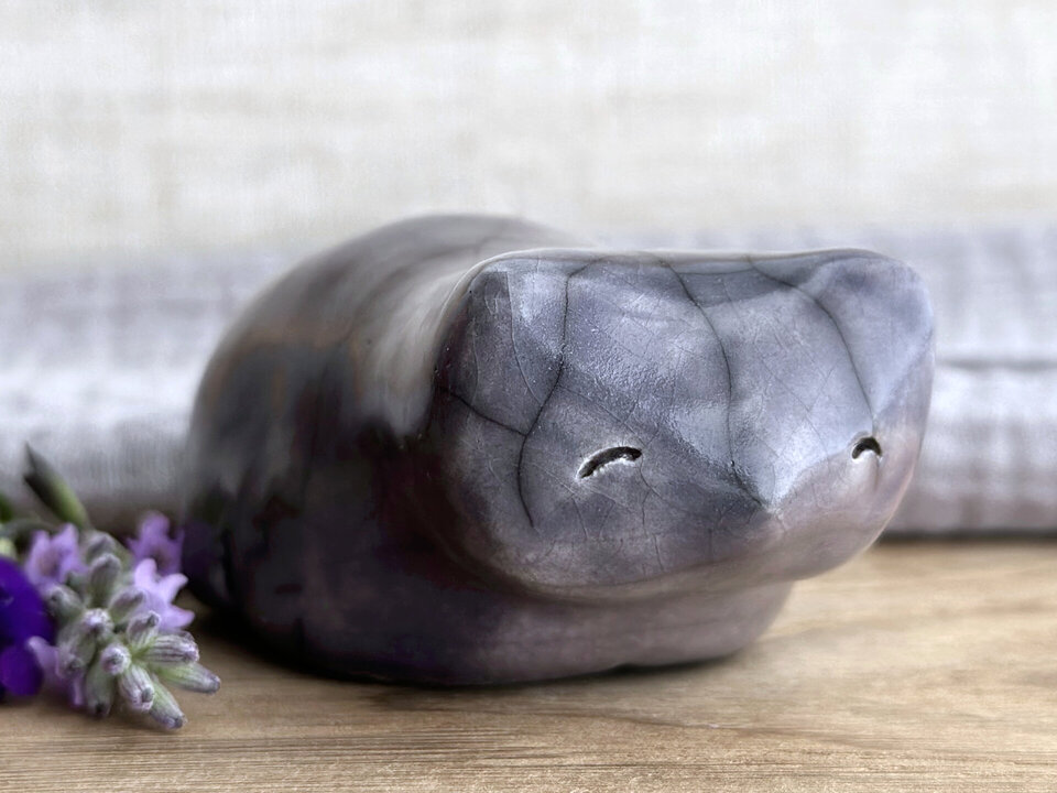 Ceramic raku bear kami sculpture glazed in soft grey violet. It has a kind, gentle face and is a little chonky.